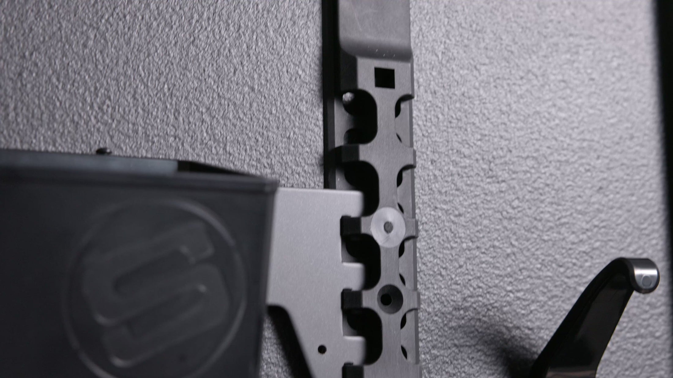 A slow motion video of a GearMate system set up on a black wall. 
