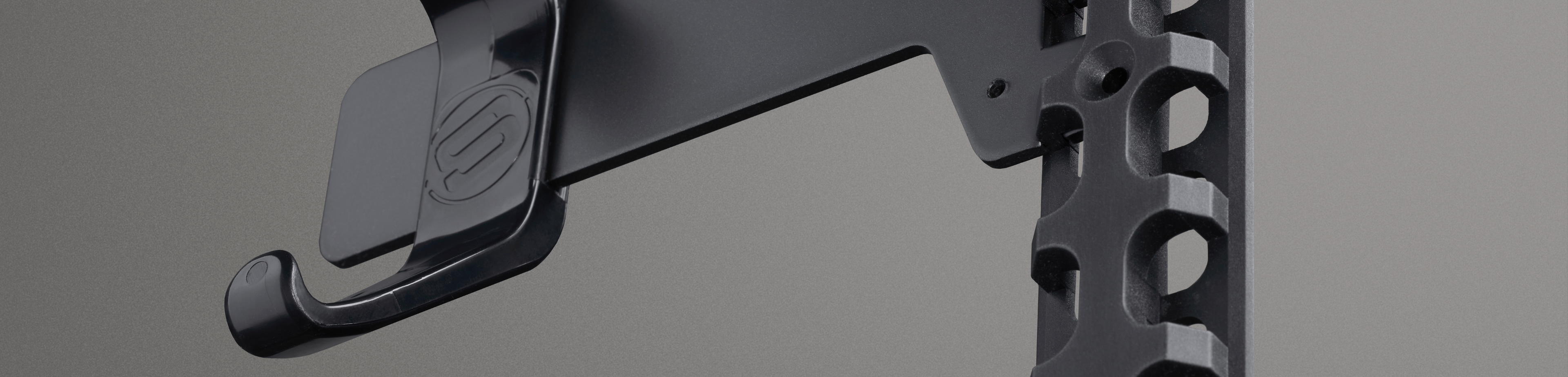 A metal bracket with a hook on a grey background. 
